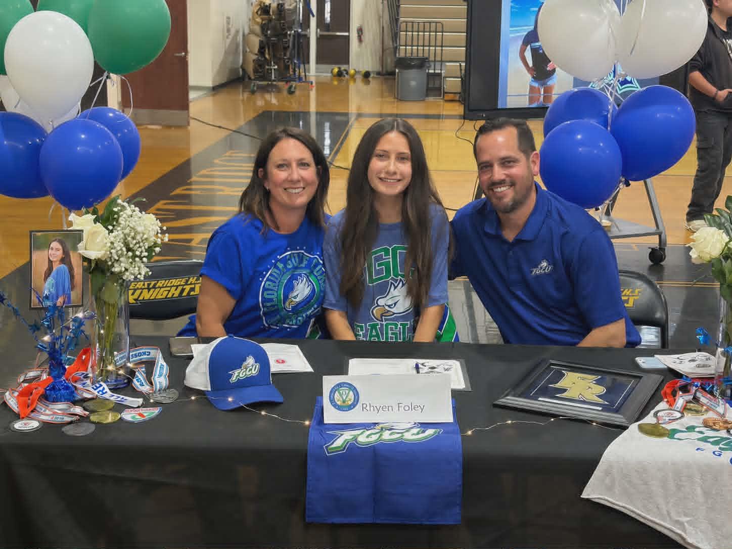 Rhyen and her parents at signing ceremony